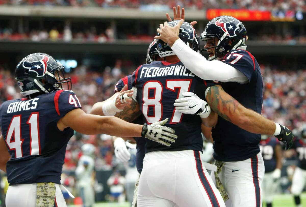 Houston Texans tight end C.J. Fiedorowicz (87) and quarterback Brock Osweiler (17) his 6-yard touchdown reception against the Detroit Lions during the second quarter of an NFL football game at NRG Stadium on Sunday, Oct. 30, 2016, in Houston.