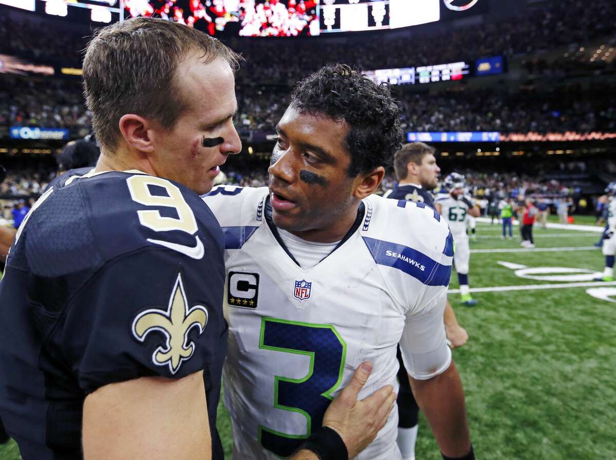 New Orleans Saints quarterback Drew Brees (9) greets Seattle Seahawks quarterback Russell Wilson (3) after an NFL football game in New Orleans, Sunday, Oct. 30, 2016. The Saints won 25-20.(AP Photo/Butch Dill)