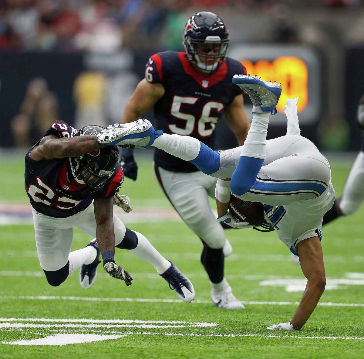 Detroit Lions wide receiver Golden Tate (15) gets upended by Houston Texans cornerback Kareem Jackson (25) during the fourth quarter an NFL football game at NRG Stadium, Sunday,Oct. 30, 2016 in Houston.