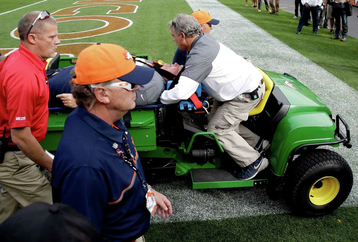 Denver Broncos offensive coordinator Wade Phillips is carted off the field after being run into by a player while on standing on the sidelines during the first half of an NFL football game against the San Diego Chargers, Sunday, Oct. 30, 2016, in Denver. (AP Photo/Jack Dempsey)