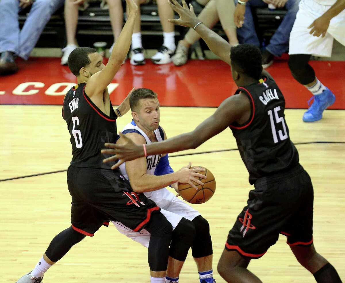 Houston Rockets guard Tyler Ennis (6) and Houston Rockets center Clint Capela (15) makes defense moves on Dallas Mavericks guard J.J. Barea (5) during the first half of the game at Toyota Center Sunday, Oct. 30, 2016, in Houston. (Yi-Chin Lee / Houston Chronicle )