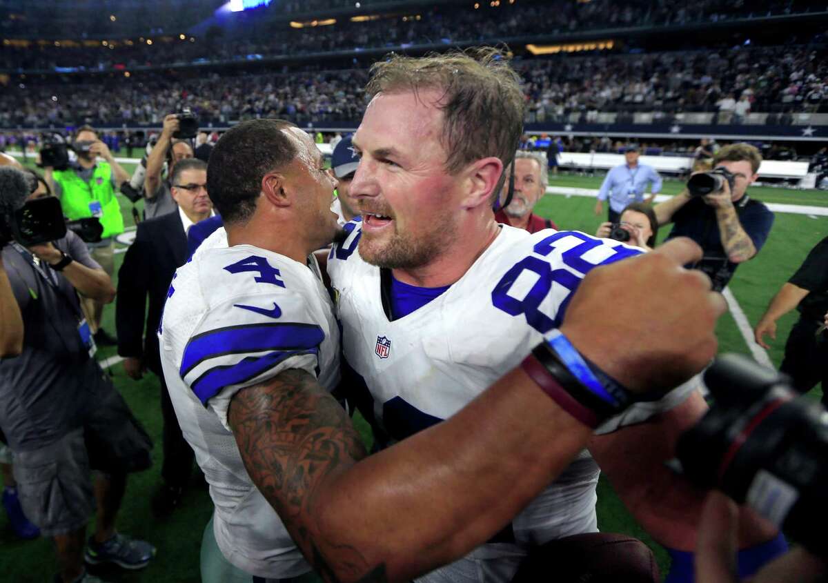 Dallas Cowboys quarterback Dak Prescott (4) and tight end Jason Witten (82) celebrate after an NFL football game against the Philadelphia Eagles on Sunday, Oct. 30, 2016, in Arlington, Texas. Prescott rallied Dallas in the fourth quarter and threw a 5-yard pass to Witten in overtime to give the Cowboys a 29-23 victory over the Eagles on Sunday night. (AP Photo/Ron Jenkins)