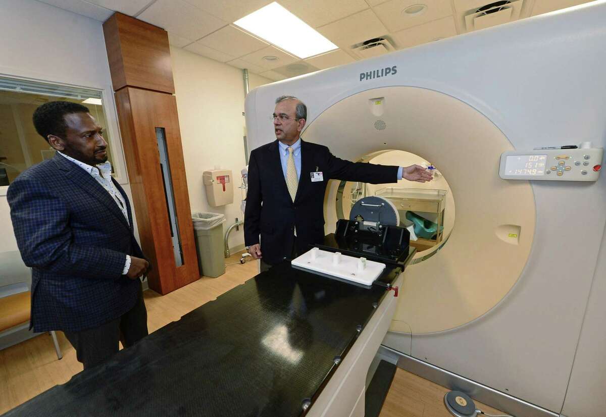 Chief of Radiation Oncology Dr. Pradip Pathare, right, explains the Philips Wide Bore 4D CT simulator as he leads a tour of the new Whittingham Cancer Center at Norwalk Hospital with Vice Chairman of the Board of Directors Andrew Whittingham on Friday. Norwalk Hospital unveiled the new Whittingham Cancer Center to the public Saturday night at a Ribbon-Cutting Celebration, where they introduced the Whittingham family and announced their donation of $4.5 million for the project.