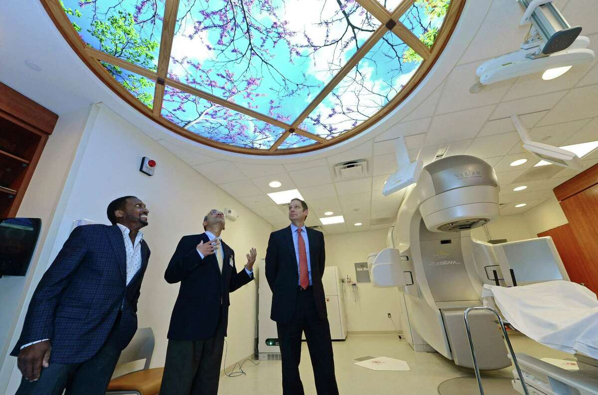 Pathare, center, leads a tour of the new Whittingham Cancer Center at Norwalk Hospital with Vice Chairman of the Board of Directors Andrew Whittingham, and, Friday, October, 28, 2016, in Norwalk, Conn. Norwalk Hospital unveiled the new Whittingham Cancer Center to the public Saturday night at a Ribbon-Cutting Celebration, where they introduced the Whittingham family and announced their donation of $4.5 million for the project.