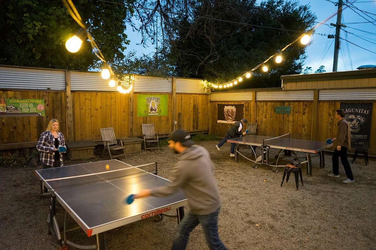 Randi Pfaff, left, plays a game of ping pong with Bryan Rood at Beer Thirty in Soquel, Calif. on Saturday, Oct. 29, 2016. Beer Thirty offers a wide variety of beers and is dog friendly.