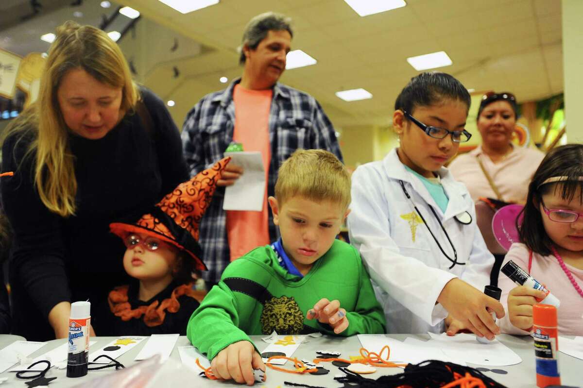 Ninja Mat Lupinacci, 4, reaches for a sticker while making a book mark during the Stamford Public Education Foundation’s Halloween Book Fair at Barnes & Noble in Stamford, Conn. on Sunday, Oct. 30, 2016.