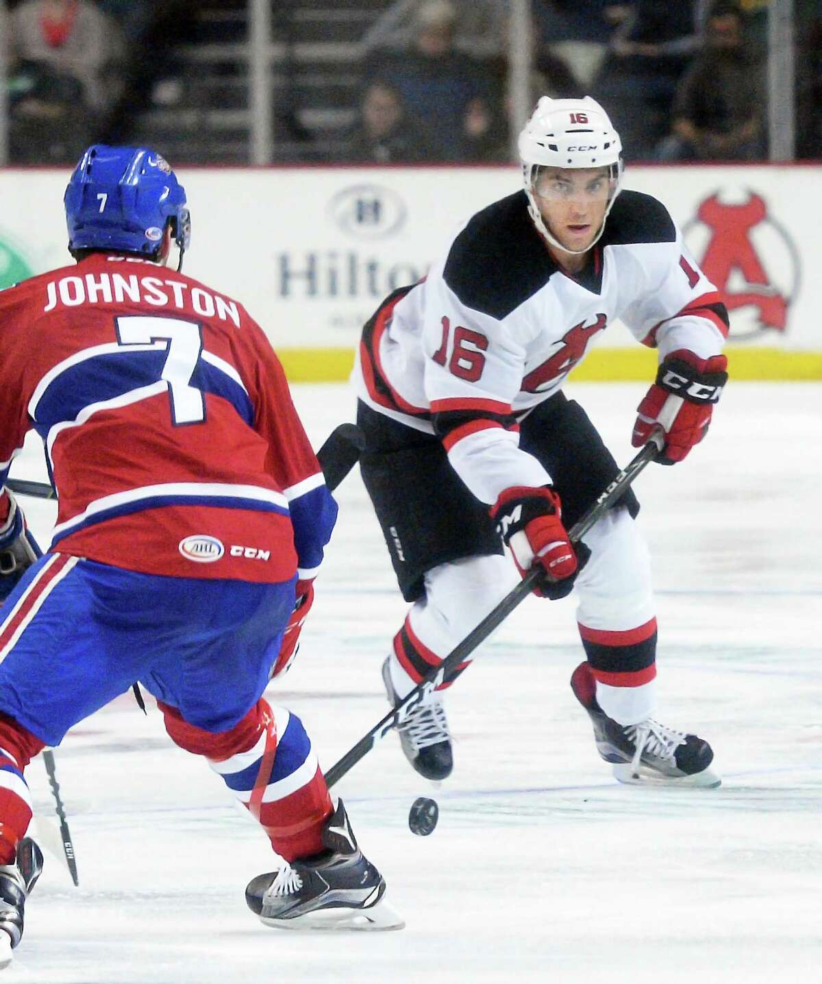 Albany Devils' #16 Ben Sexton works his way past St. John's IceCaps' #7 Ryan Johnston during Saturday's home opener at the Times Union Center Oct. 15, 2016 in Albany, NY. (John Carl D'Annibale / Times Union) ORG XMIT: MER2016101520303044