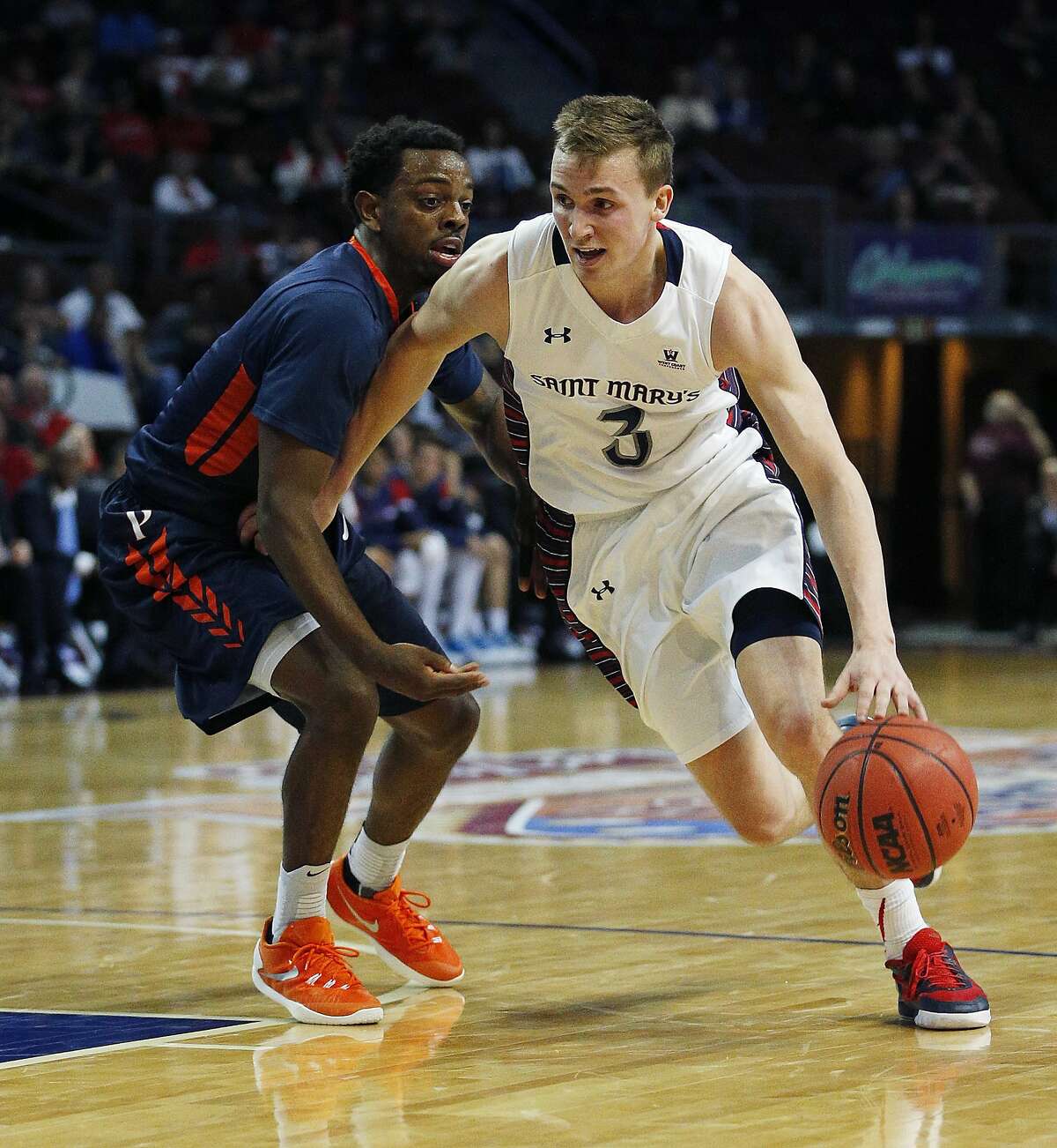 Saint Mary's guard Emmett Naar, right, drives around Pepperdine guard Jeremy Major during the first half of a West Coast Conference tournament NCAA college basketball game Monday, March 7, 2016, in Las Vegas. (AP Photo/John Locher)