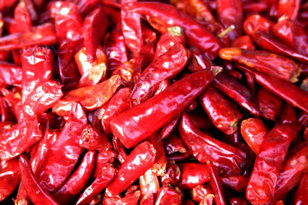 Dried peppers sit awaiting sale in a wholesale market in Chengdu, China, Nov. 28, 2003.