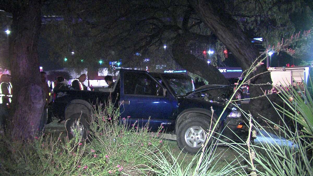 A woman was briefly pinned inside her pickup after crashing into a tree following a two-vehicle accident on the South Side on Oct. 31, 2016.