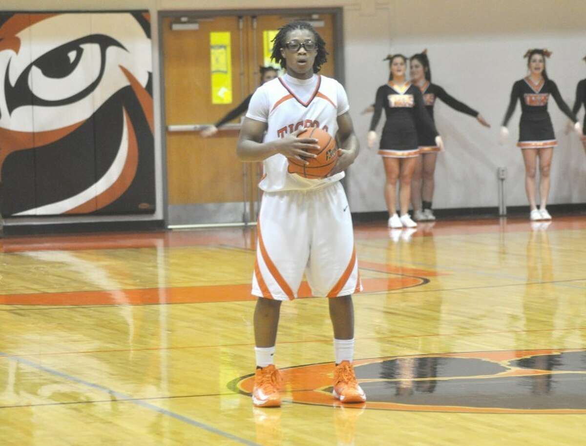 Edwardsville’s Shawn Roundtree holds the ball at mid court toward the end of the first half for the Tigers on Friday at Lucco-Jackson Gym against the O’Fallon Panthers. EHS won the game 75-61.