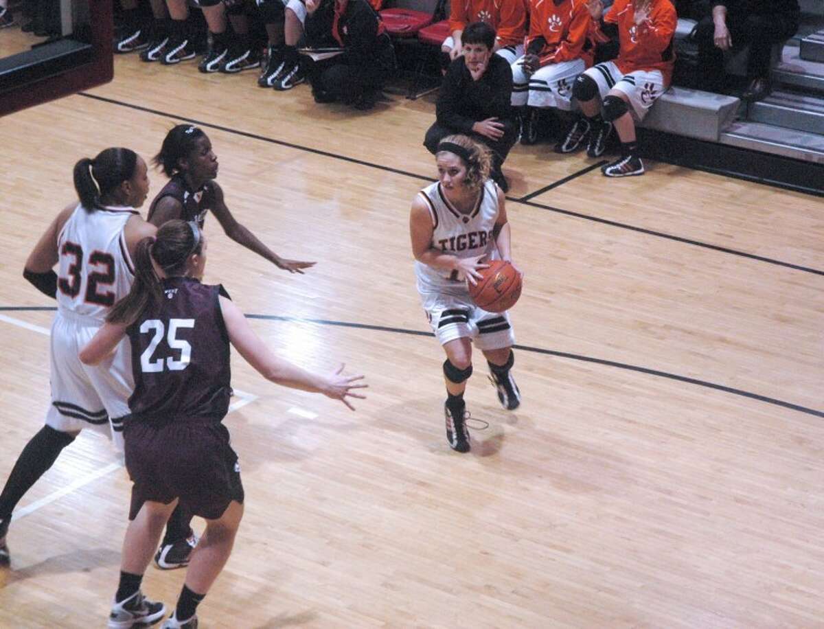 Tiger guard Caty Ponce looks to pass the ball inside during the third quarter of the Normal Community Sectional semifinals against Belleville West at Granite City. EHS won 51-46.