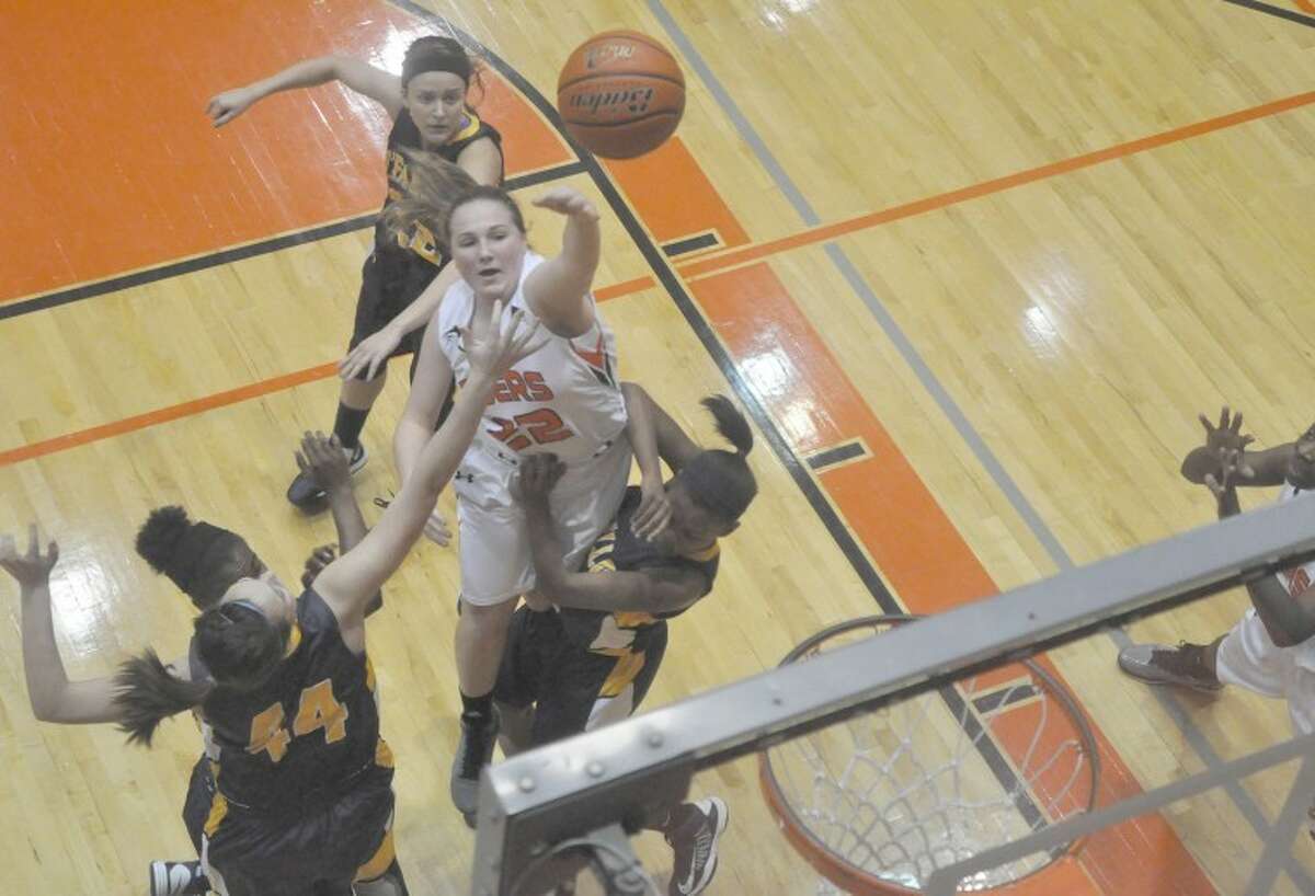 Edwardsville senior guard Sydney Bloch throws up a shot over two O’Fallon defenders during second-quarter action at the Lucco-Jackson Gymnasium on Thursday