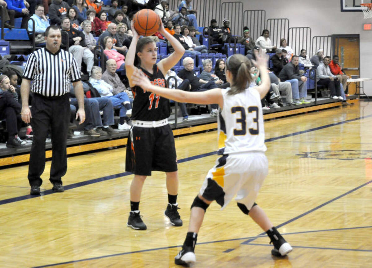Edwardsville’s Maddi George looks for an open teammate late in the second quarter against O’Fallon. 