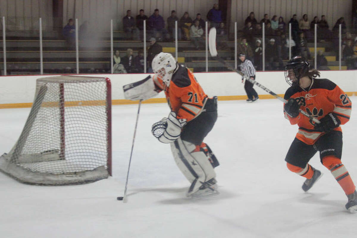Edwardsville goalie R.J. Pluhar handles the puck during the first period of Thursday’s game against Bethalto at the East Alton Ice Arena. 
