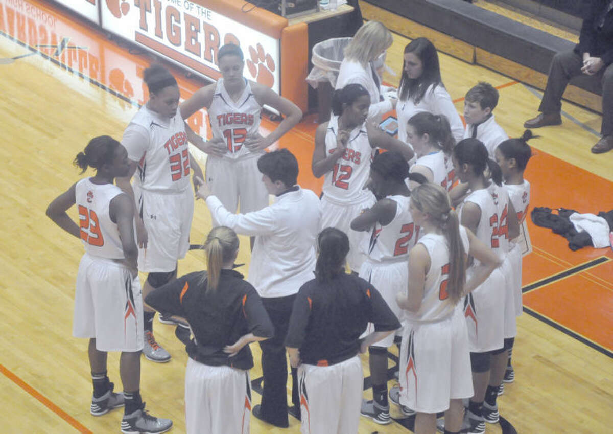 Edwardsville Tiger girls’ basketball head coach Lori Blade, center, talks to her team during a break in the action against Minooka on Dec. 28 at the Lucco-Jackson Gymnasium. The Edwardsville Tiger girls’ basketball team finished the 2012-13 season with a 30-1 record. They claimed Southwestern Conference and regional championships, as well as three regular-season tournament titles.