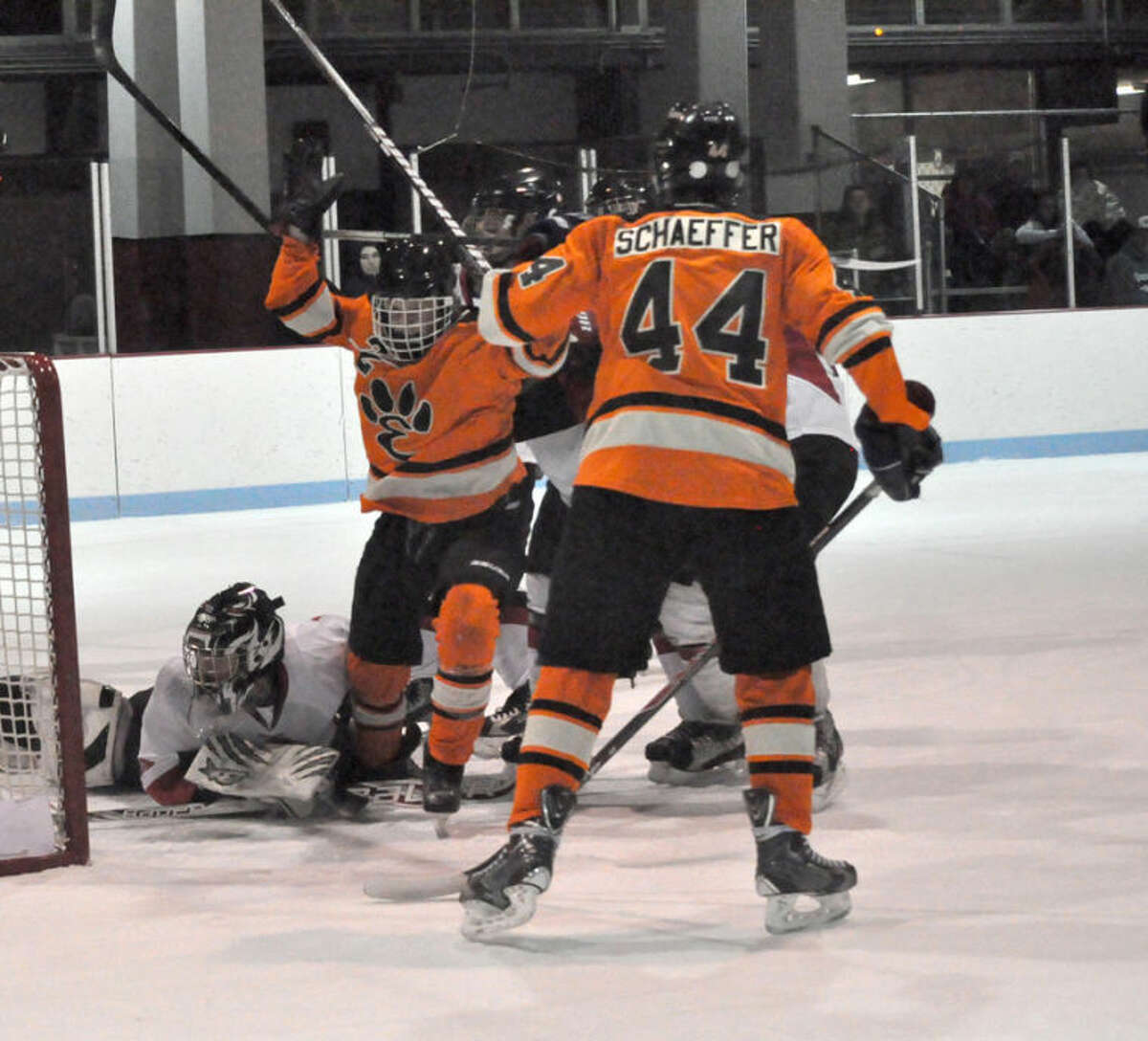 Tiger Tyler Hinterser, left, celebrates his third goal of the game midway through the third period. Edwardsville defeated Granite City 7-3.  