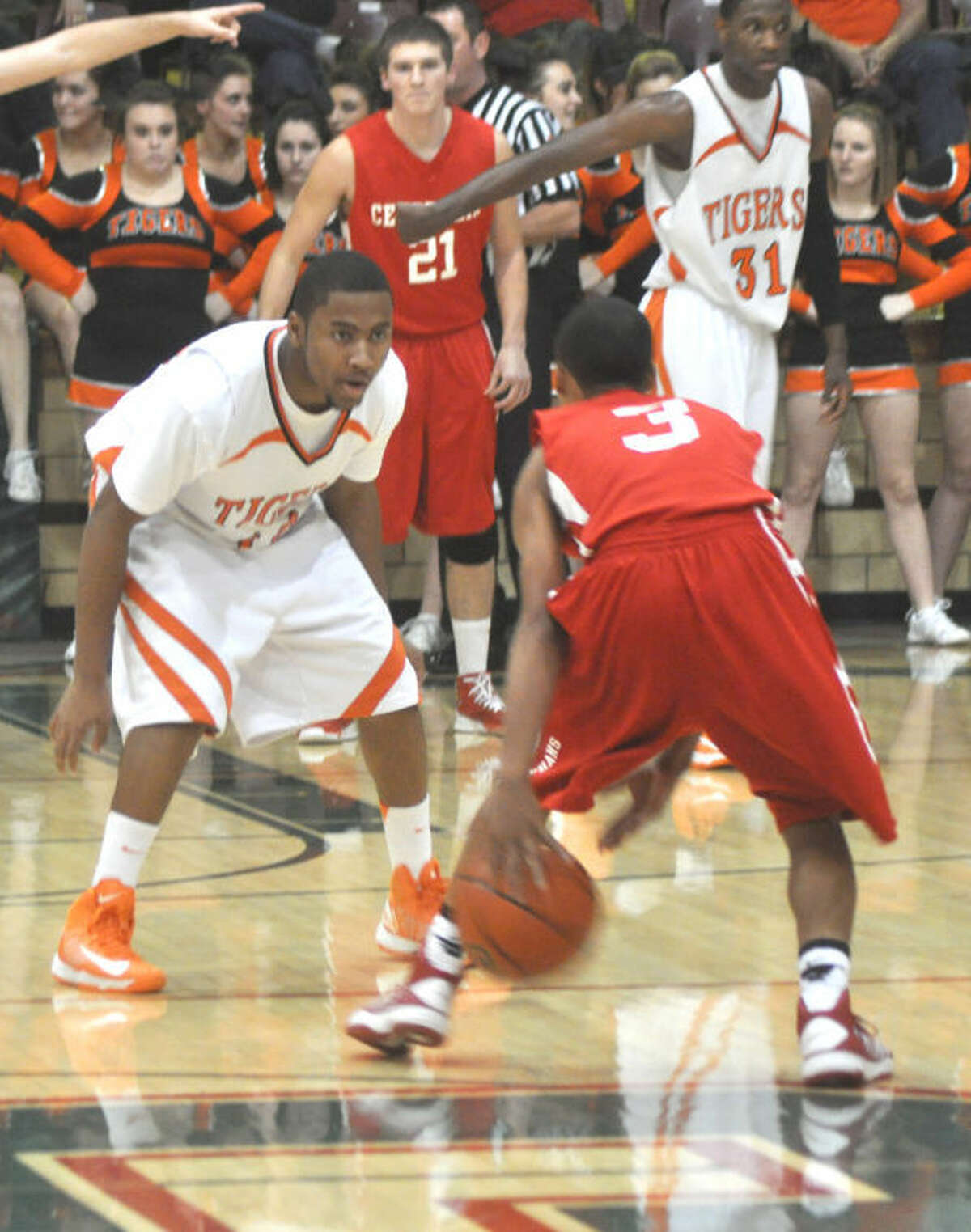 Tiger Darius Crochrell plays defense on D’Aaron Owens of the Orphans on Saturday.