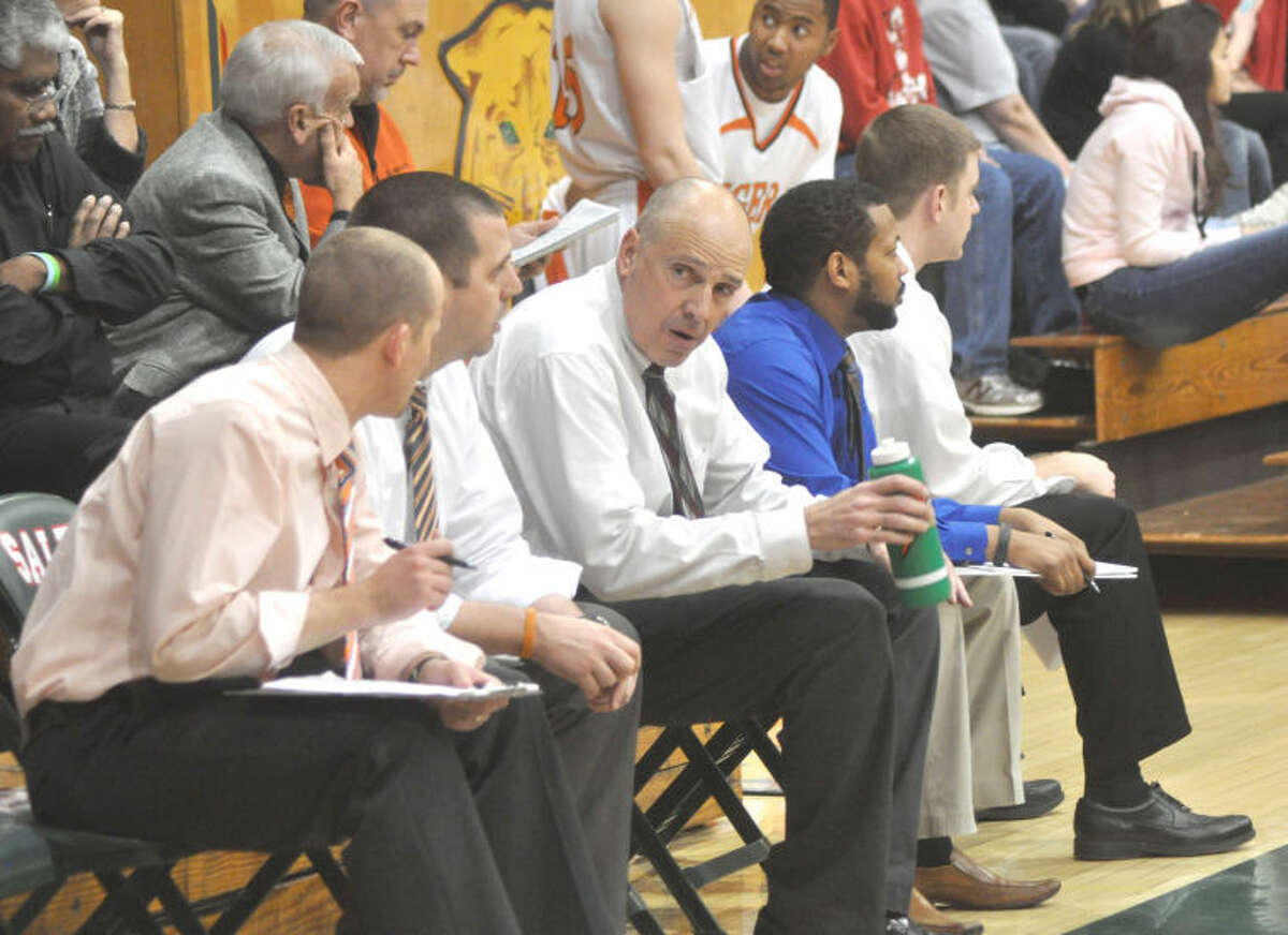 Edwardsville Tiger head coach Mike Waldo, center, and the EHS boys’ basketball coaching staff sit on the sidelines in the finals of the 62nd Annual Salem Invitational tournament on Saturday. The Tigers will face their toughest tests of the season so far at 7:30 p.m. tonight at Belleville East and at 8 p.m. Saturday at the Pinckneyville Shootout against Cahokia.