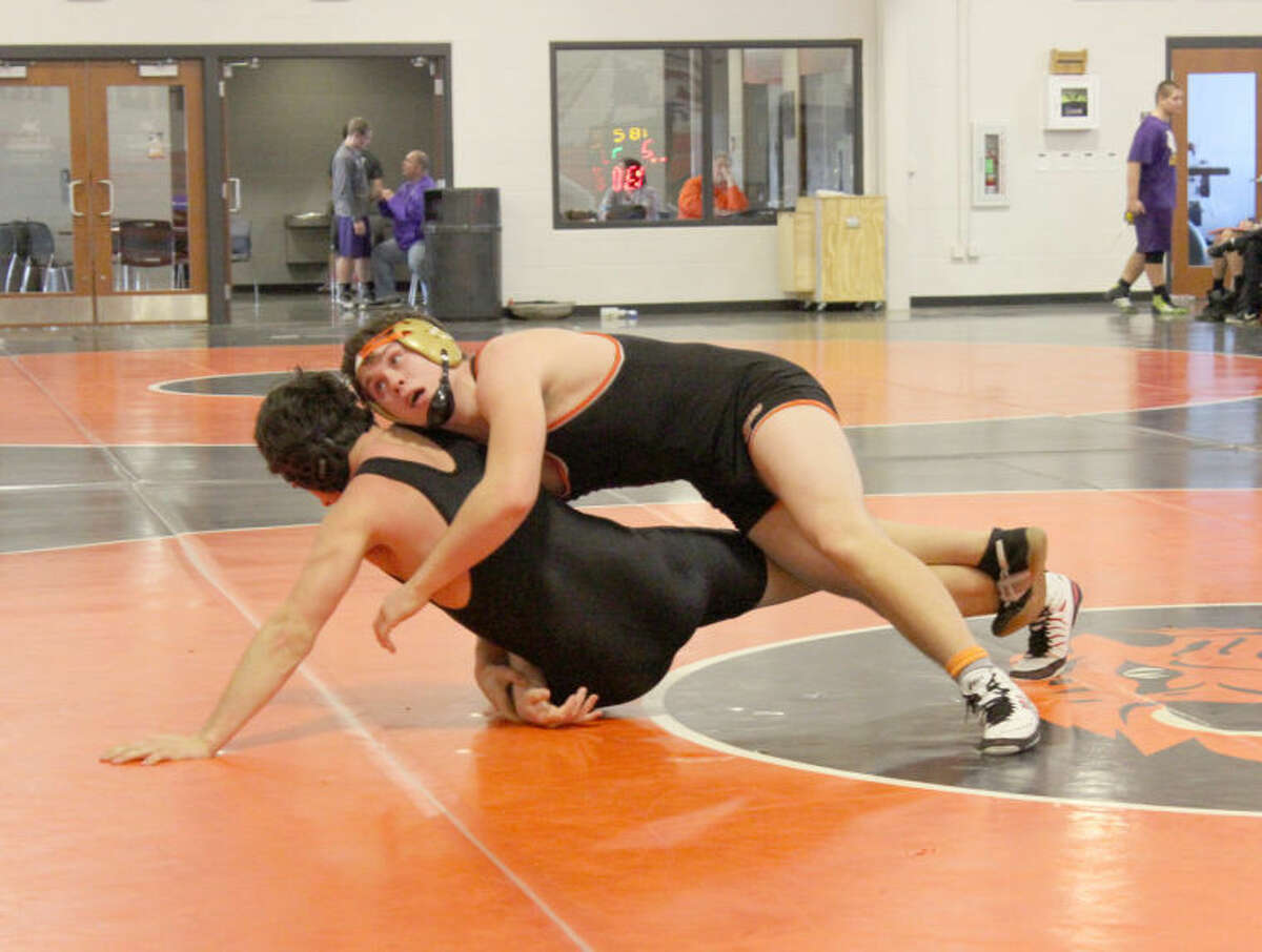 Edwardsville’s Cameron Throneberry, top, battles with Litchfield’s Bryce Thorton in an 182-pound match on Saturday. Throneberry won by pin at 3:38.
