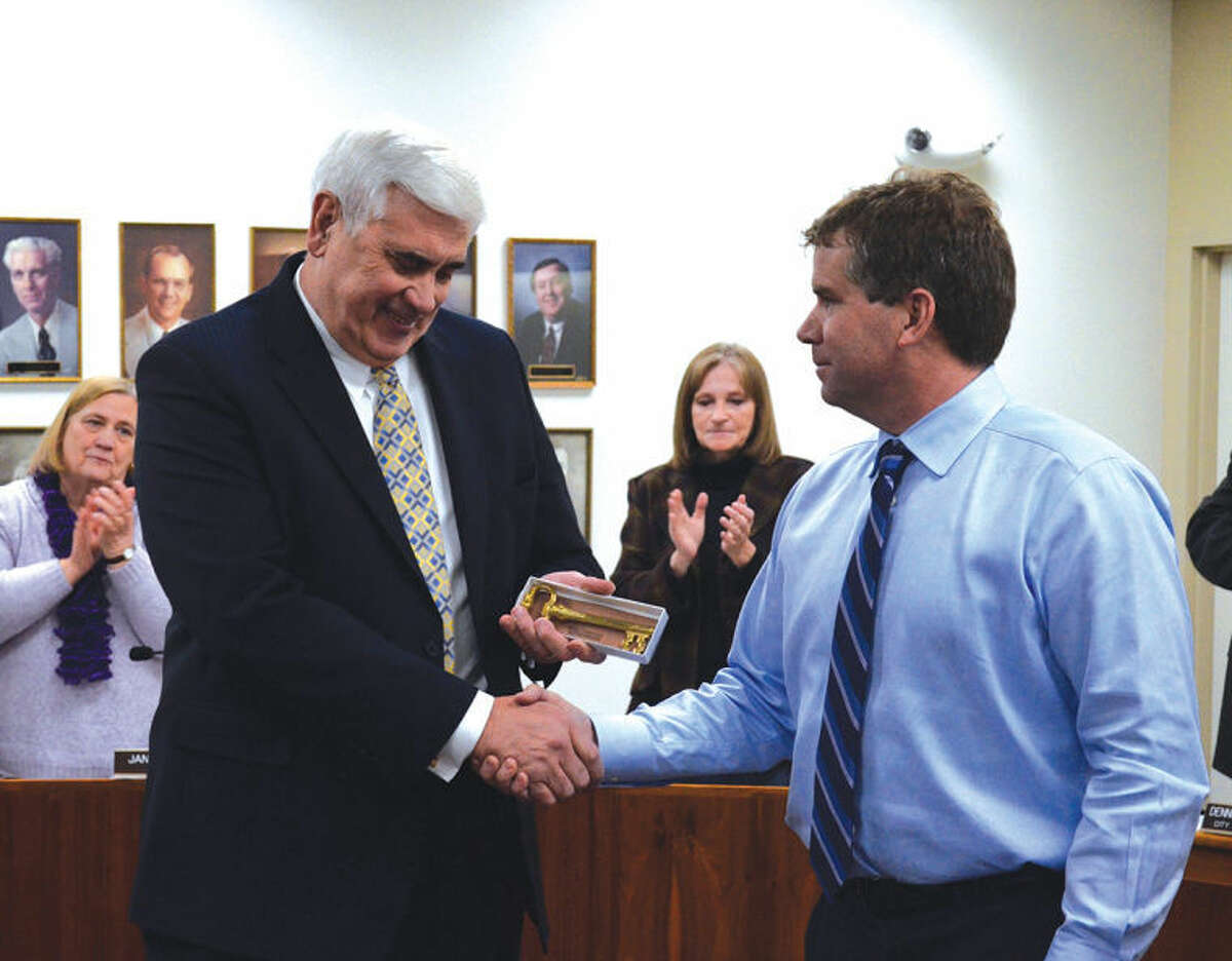 Edwardsville City Administrator Ben Dickmann, left, receives a ceremonial key to the city from Mayor Hal Patton. After 44-plus years of public service, Dickmann announced his retirement plans at Tuesday's City Council meeting.