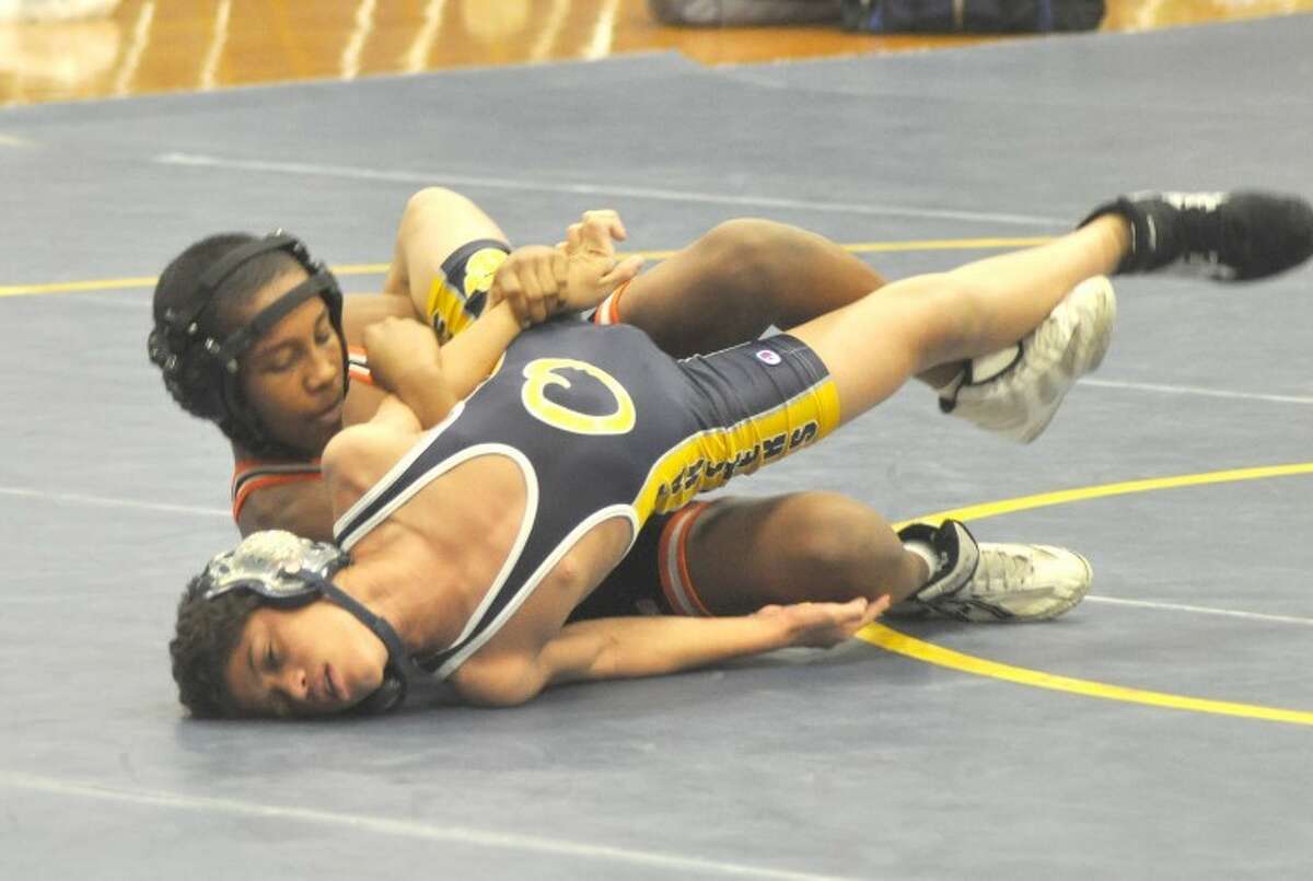 Edwardsville Tiger James Ziegler puts a hold on O'Fallon's Darius Holt Wednesday at O'Fallon Township High School. Ziegler won his match by pin and the Tigers won the dual 45-12.