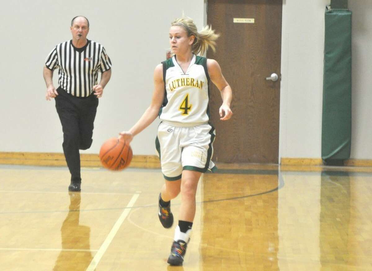 Metro-East Lutheran's Jessica Jump dribbles down court on Monday at Thomas Hooks Gym against Wesclin. The Warriors beat the Knights 44-32.
