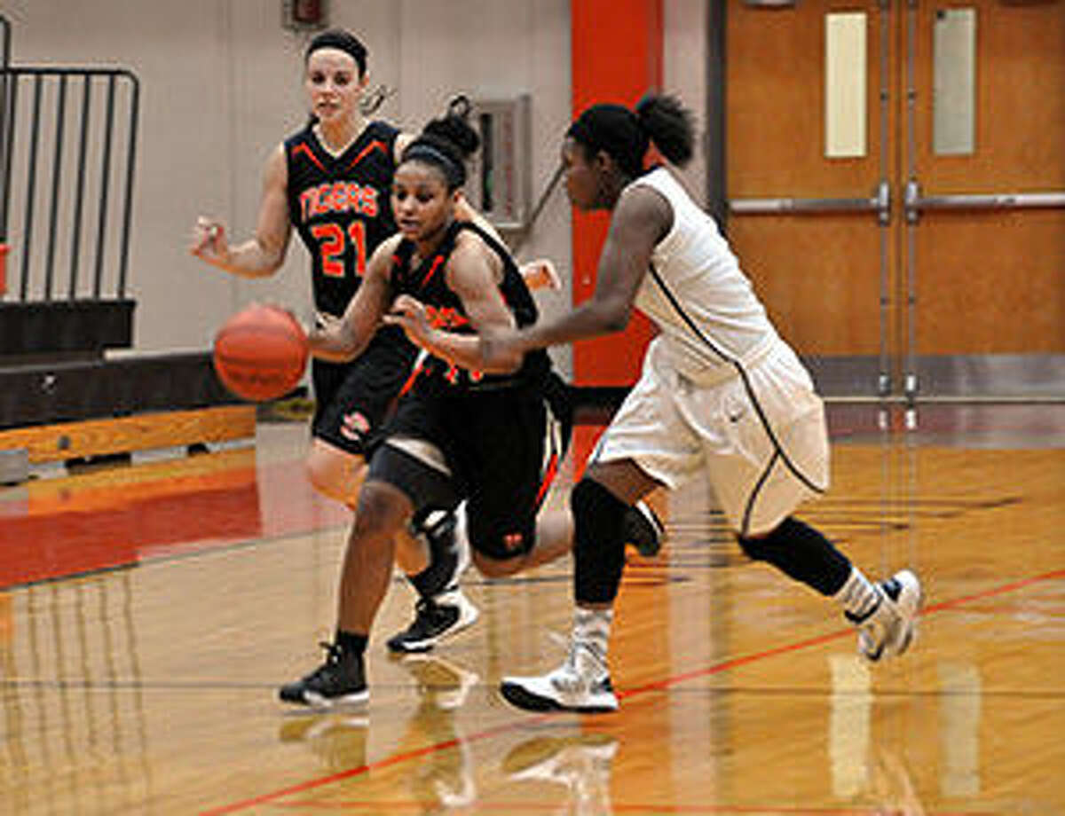 Edwardsville point guard Amayha Dycus races past a McCluer North defender near mid-court.