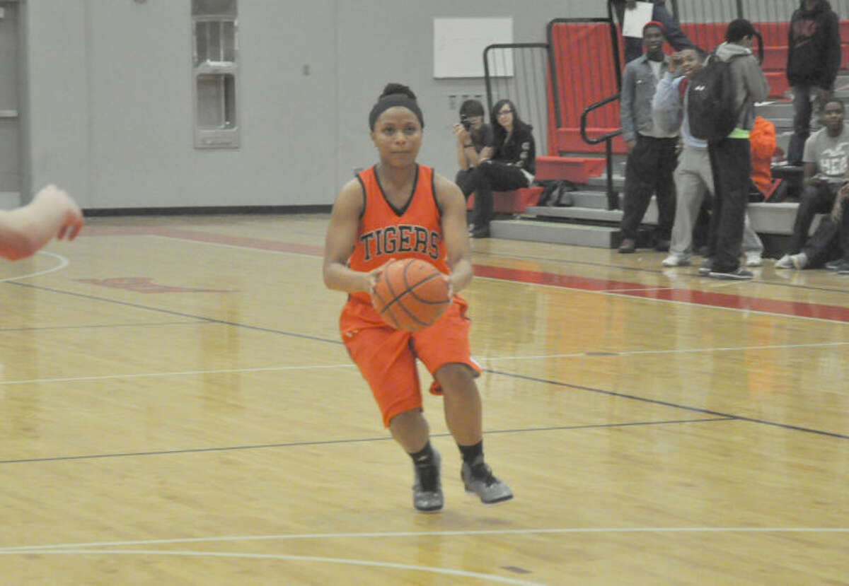 EHS junior guard Leeah Jason squares up for a shot late in the fourth quarter. Edwardsville completed its first-ever undefeated regular season with a 102-39 win over Alton. 