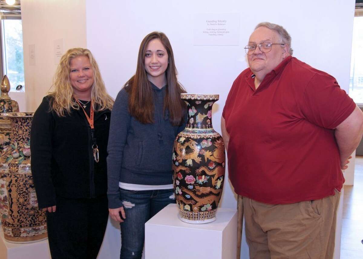 Dixie Patrow, an English teacher at EHS at left, with EHS student Danielle Bahmani, and Director of the SIUE University Museum Eric Barnett, and a vase titled "Guarding Silently," from the University Museum's collection.