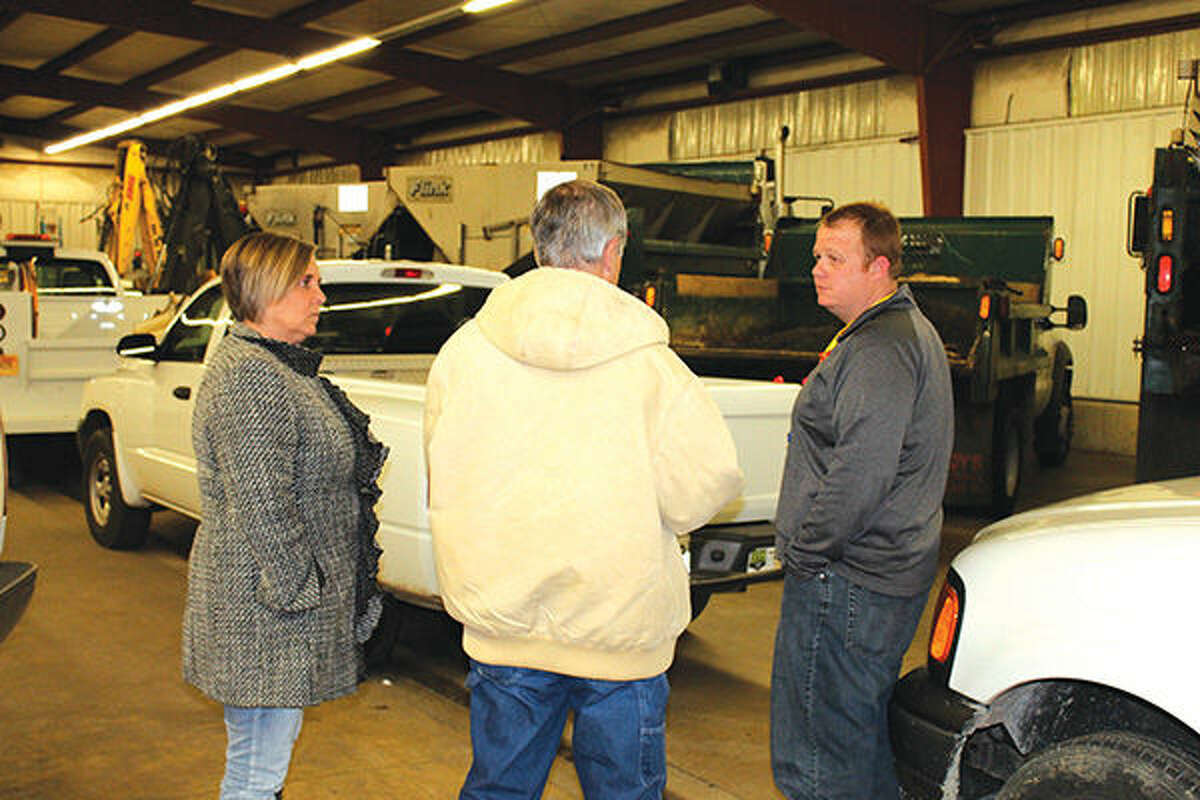 Glen Carbon Public Works Coordinator Mike Govreau, center, talks with Village Trustees Mary Ann Smith and Ross Breckenridge during a tour of the Public Works garage as part of Tuesday's Public Services Committee meeting.