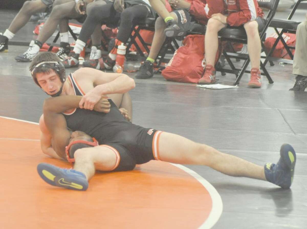 Edwardsville's Kyle Jackson attempts to pin Alton's Quiante Wagner during a bout at 145 pounds at the Jon Davis Center on Thursday. The Tigers defeated the Redbirds 44-17 and the Althoff Crusaders 75-0.
