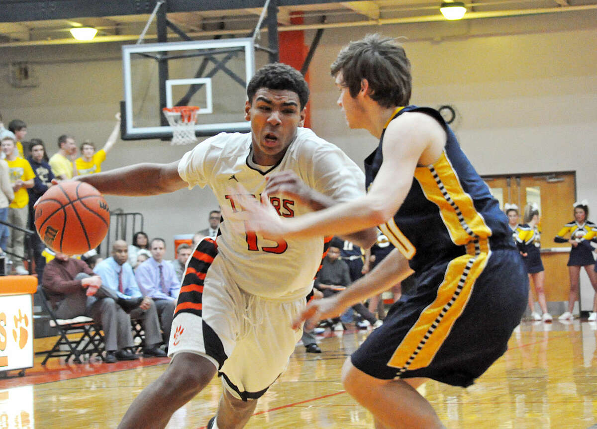 Edwardsville sophomore guard Mark Smith, left, tries to drive to the basket past an O'Fallon defender on Friday.