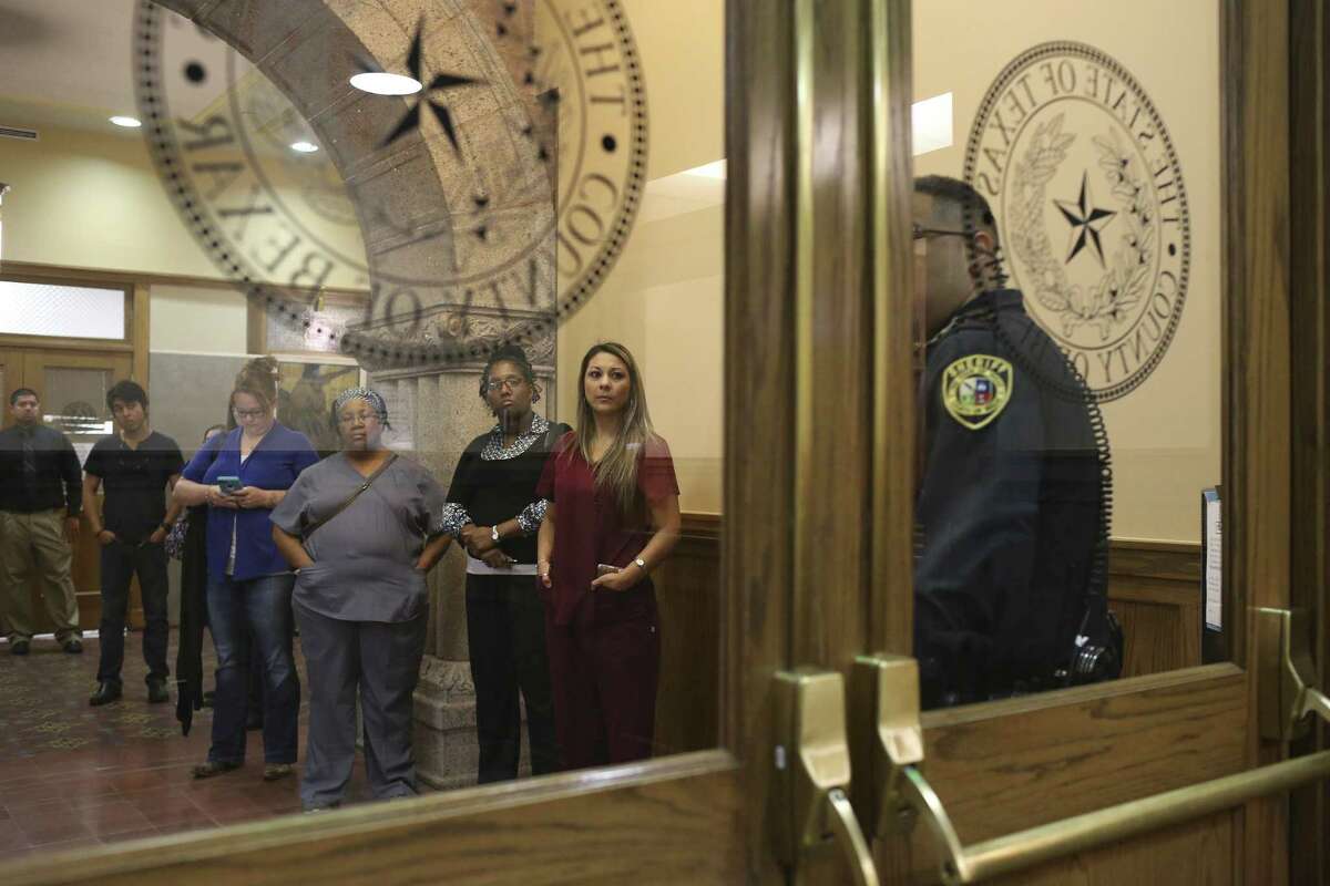 A bailiff (from right) stands by as plaintiffs Jennifer Espiricueta, Tarnisha Martin, Leilani Hagan and Erica Lindsey await a hearing before their lawsuit was taken up by the bankruptcy court.