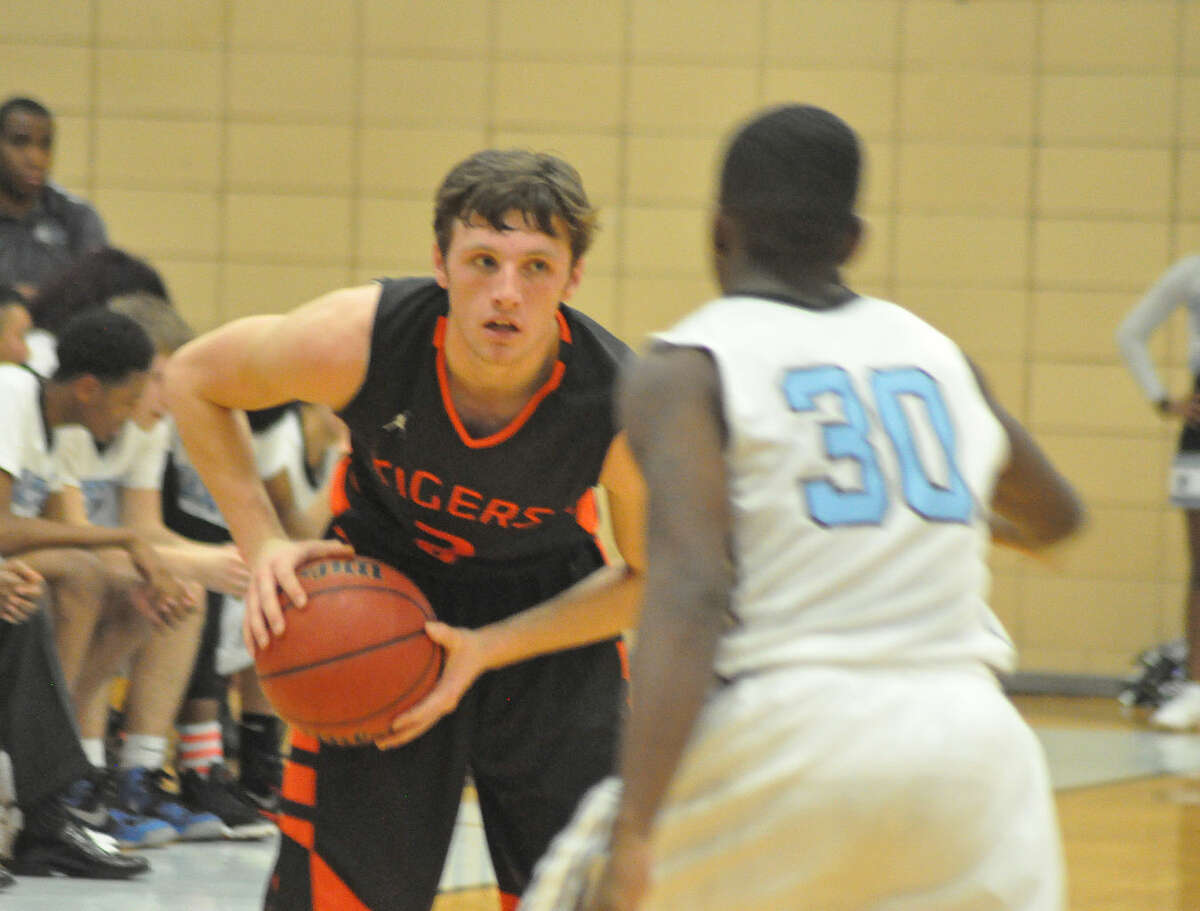Edwardsville senior guard Dan Marinko shields the ball away from a Gateway Tech defender on Tuesday in St. Louis.