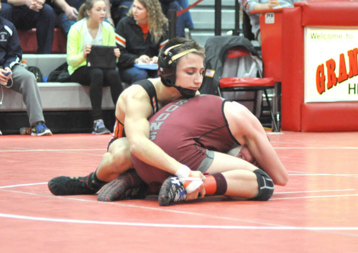 Edwardsville’s Tanner Ambry looks to get positioning against Belleville West’s Cooper Secker during the championship bout at 106 pounds on Saturday at the Class 3A Granite City Regional.  