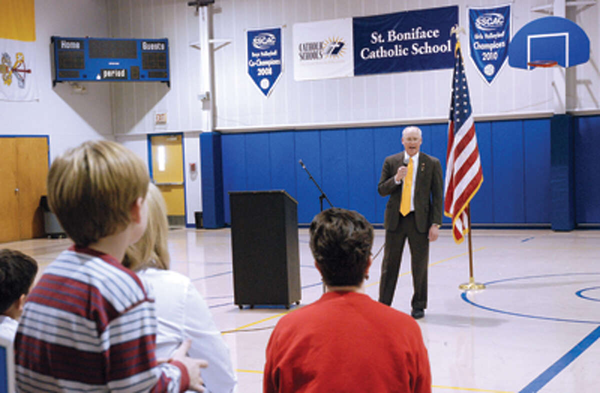 Doug Garbs addresses a gathering of students and teachers Tuesday at St. Boniface Catholic School.