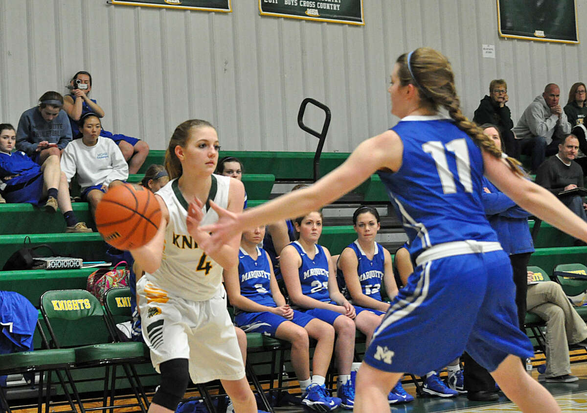Metro-East guard Danielle Timmerman, left, passes the ball to an open teammate late in the second quarter.