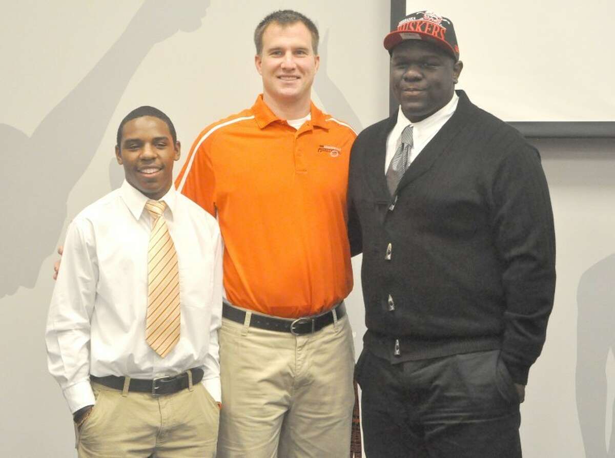 Edwardsville Tiger football player Vincent Valentine made his long awaited announcement on where he would attend college at 1 p.m. Wednesday at the Jon Davis Wrestling Center, choosing the University of Nebraska. Teammate Cameron James joined Valentine at the press conference, announcing he will attend McKendree University to play football and run track. Pictured from left to right are: James, EHS head football coach Matt Martin and Valentine.