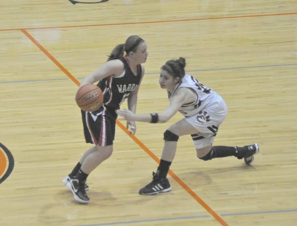 Edwardsville's Sarah Parker, right, attempts to knock the ball away from Granite City's Paige Luehmann during the first quarter at Lucco-Jackson Gymnasium on Tuesday. EHS won 48-12.