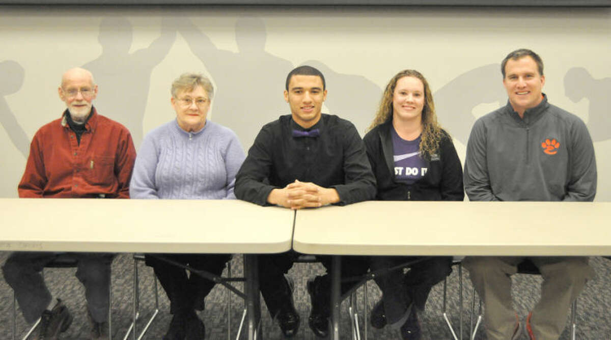Edwardsville’s D’Anthony Knight recently signed a letter of intent to continue his football career at Truman State University in Kirksville, Mo. Pictured above from left to right are: Richard Knight, grandfather, Dorina Knight, grandmother, D’Anthony Knight, Shana Knight. mother and EHS head football coach Matt Martin.