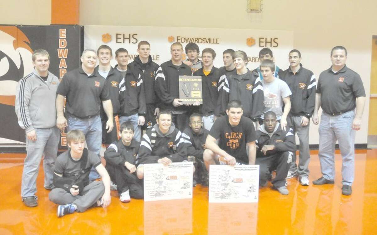 The Edwardsville Tiger wrestling team poses with their Class 3A Edwardsville Regional championship plaque while Dillon Soliben and Blake Blair hold their individual title cards. It was a stellar season for EHS in 2011-12.