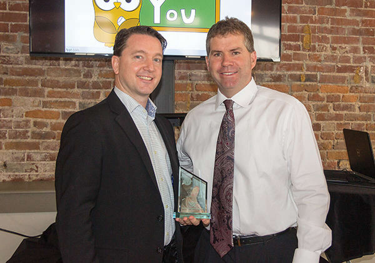 World Wide Technology Director of Supply Chain David O'Toole, left, holds the 2015 Business of the Year Award after it was presented by Edwardsville Mayor Hal Patton.