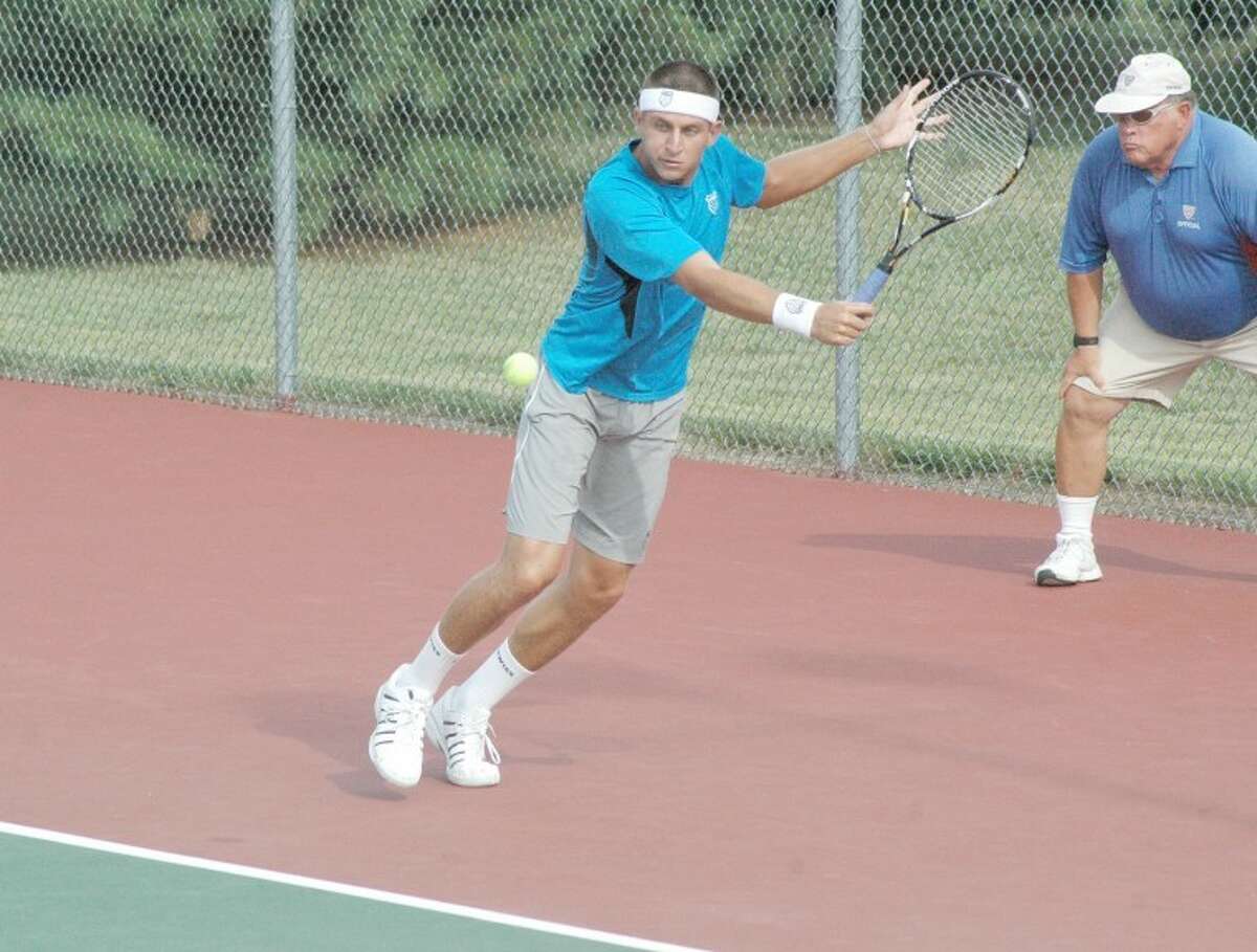Devin Britton lunges for a backhand return during singles action on Wednesday at the EHS Tennis Center in the Edwardsville Futures Tournament. Britton was the 2009 NCAA singles national champion while playing at the University of Mississippi.