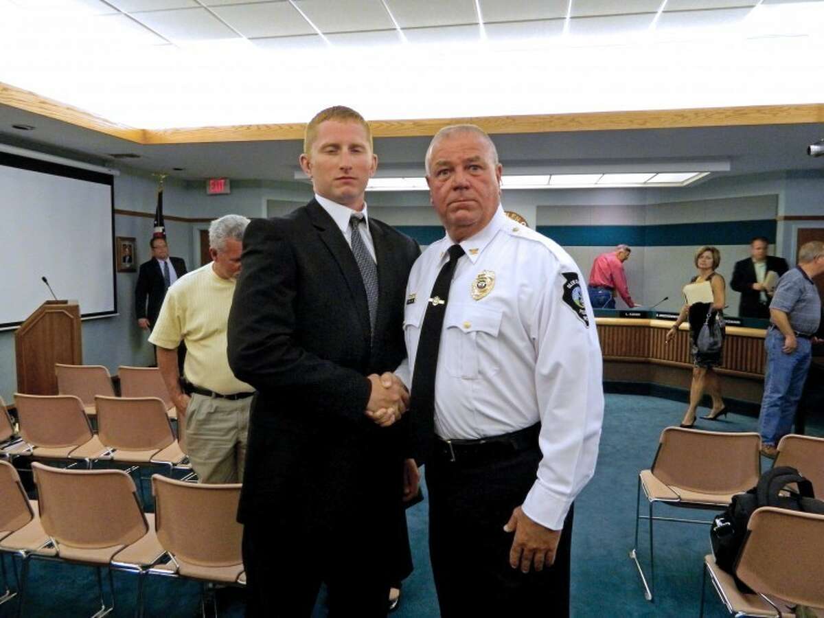 Chief John Lakin, right, welcomes Justin Click to the police department.