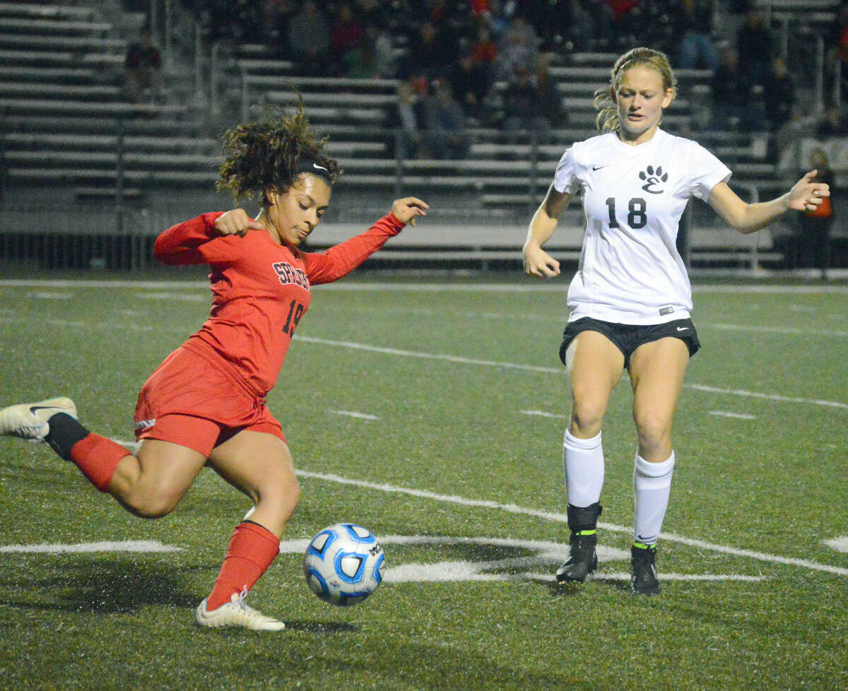 Edwardsville junior Abby Crabtree, right, tries to keep a Springfield player from passing the ball down the field in the first half.