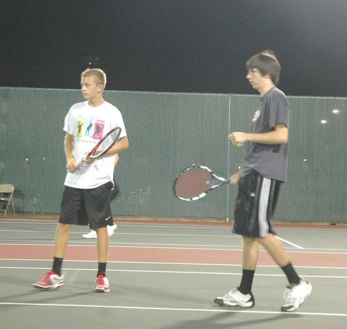 Edwardsville players, Jack Desse, left, and Cameron Randall, right, compete in doubles action Monday in the wildcard tournament at the EHS Tennis Center.