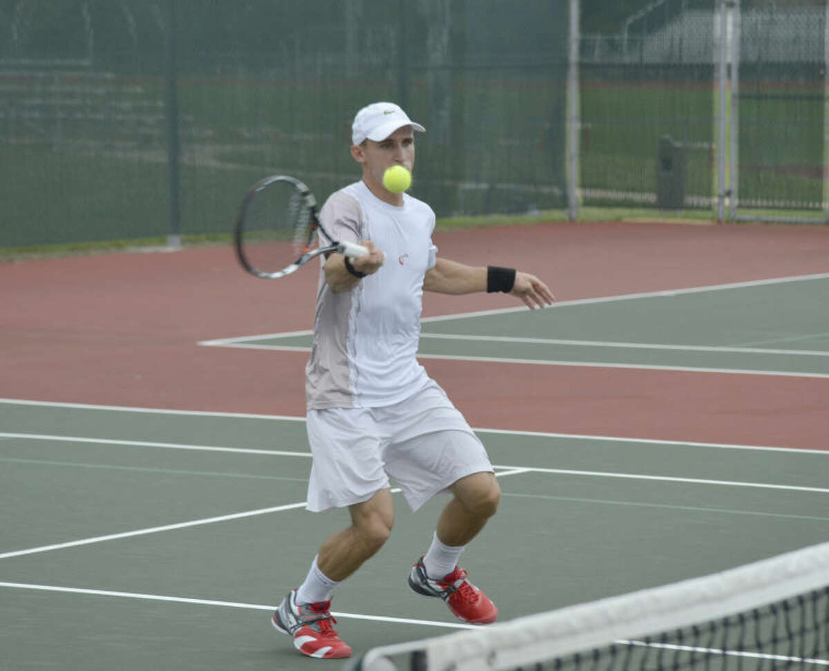 Dimitar Kutrovsky hits a shot at the net during his match at the USTA Edwardsville Futures on Thursday.