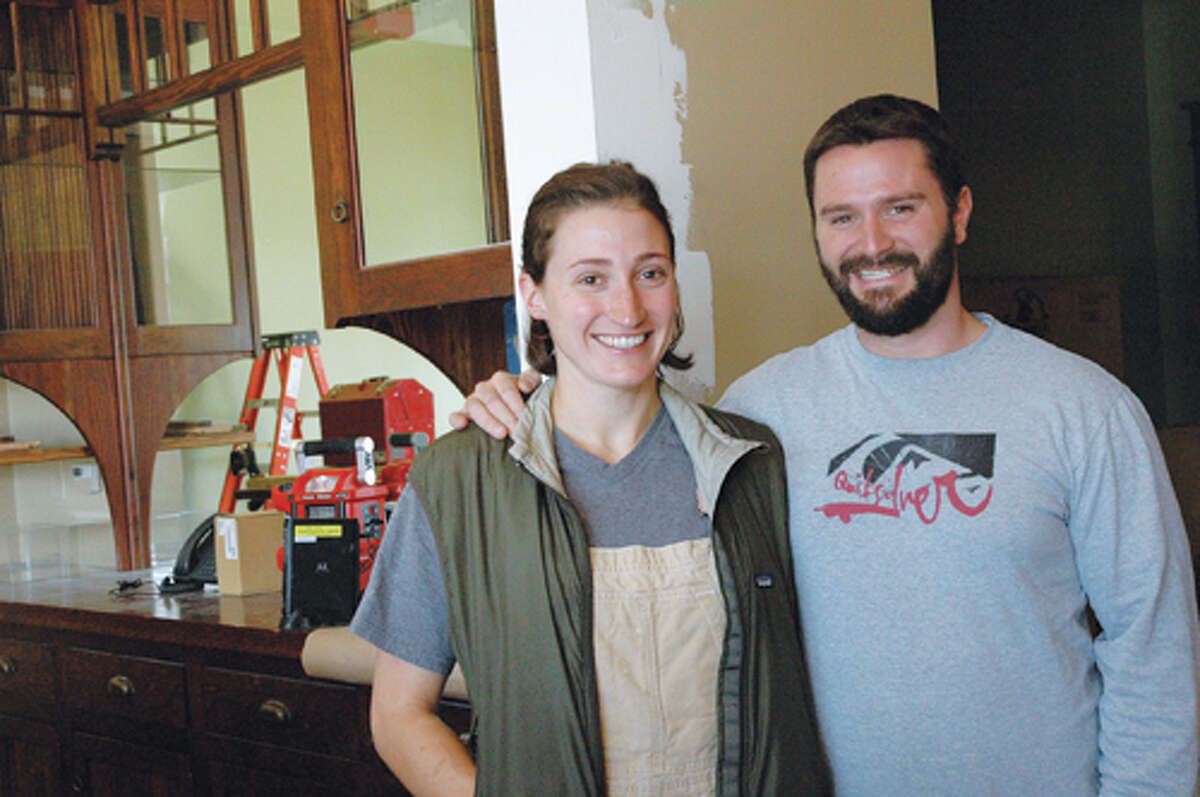 Jennifer Cleveland and Ed Heath stand behind the bar of their restaurant-in-the-making at 106 N. Main St. A late November opening is planned.