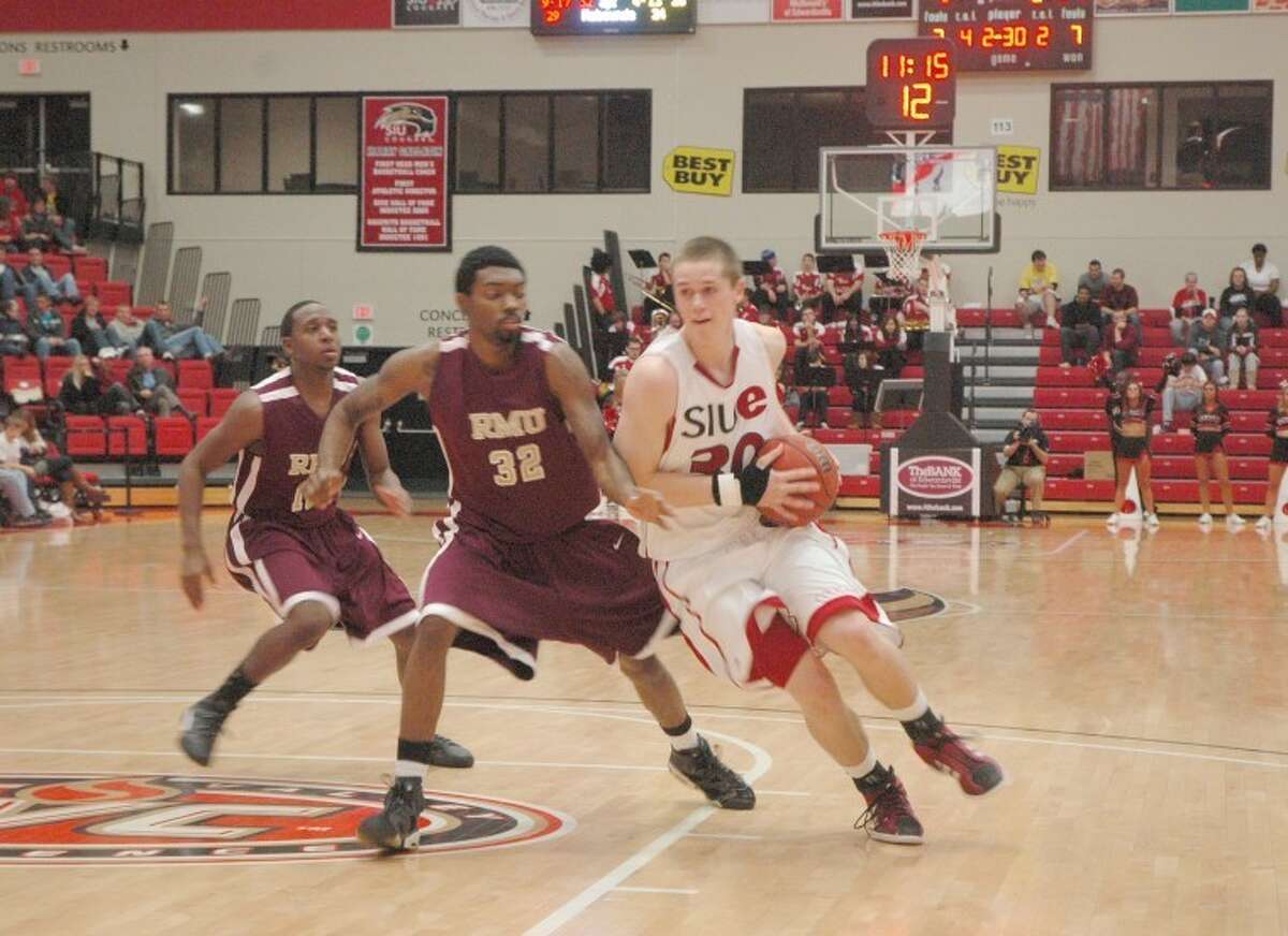 SIUE's Michael Messer, right, drives the ball against Robert Morris' Jordan Softley on Wednesday at the Vadalabene Center. The Cougars defeated the Eagles 85-61 in their home opener.